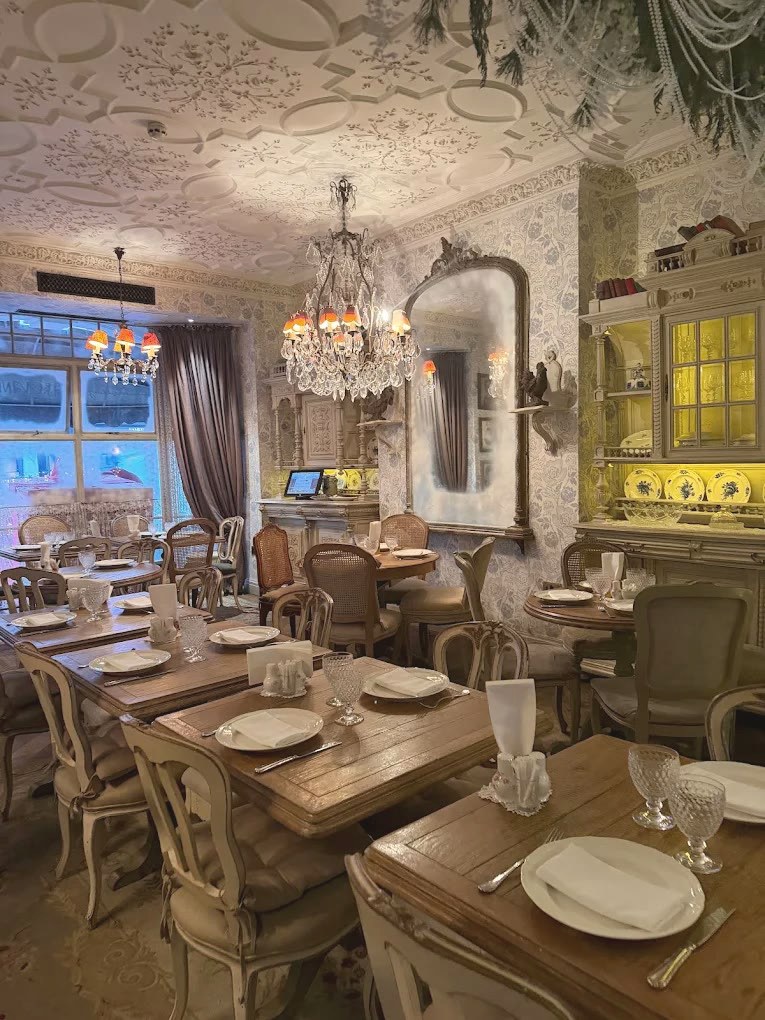 Crystal chandelier and gilt mirror by the window